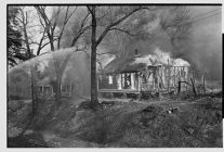 Firemen burning old houses 
